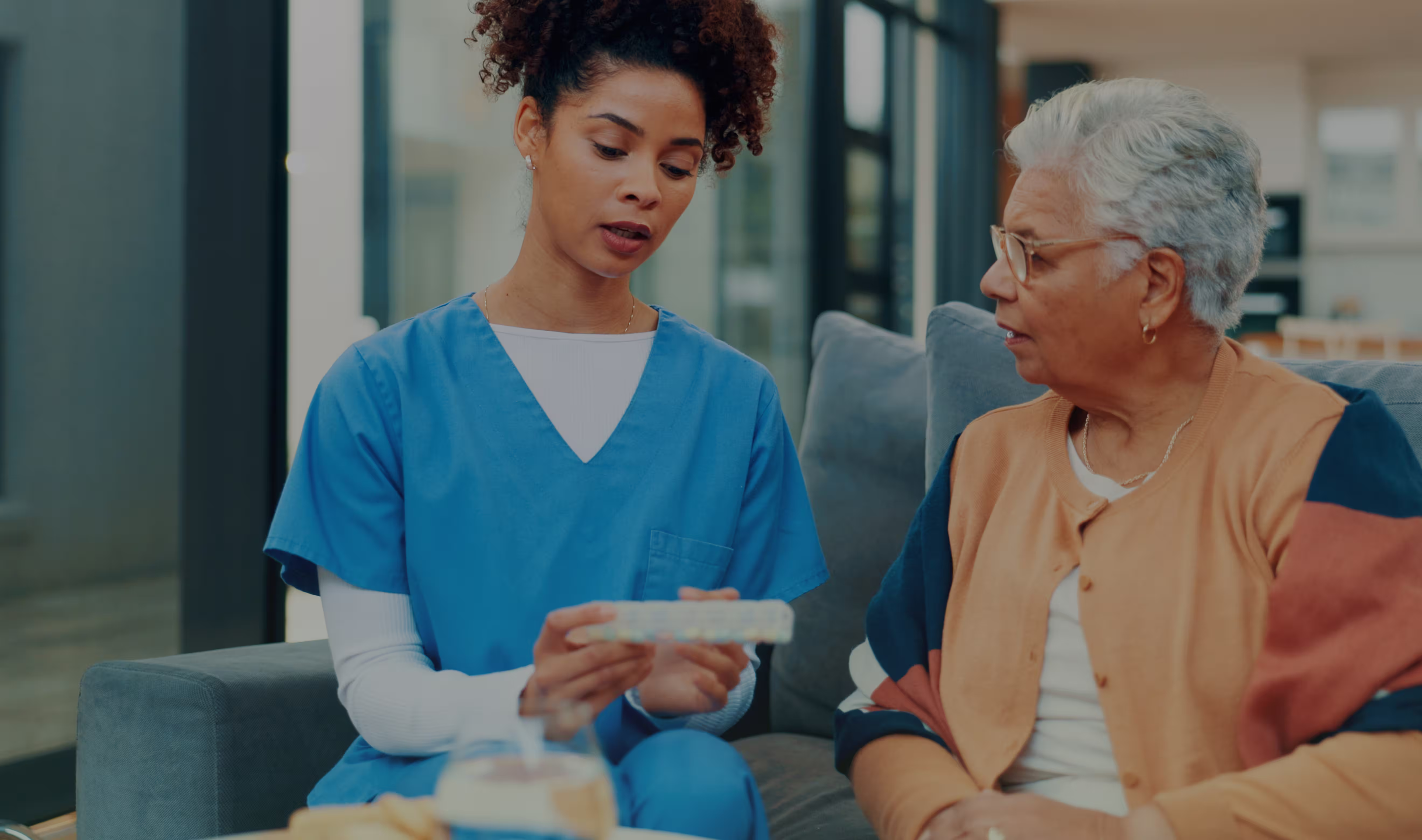 Friendly caregiver helping resident with daily activity