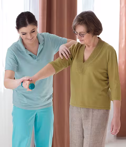 Care staff interacting warmly with resident